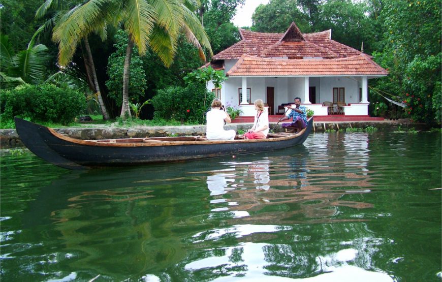 Foreigners and boatman in the rover boat of Alleppey Homestay Backwaters